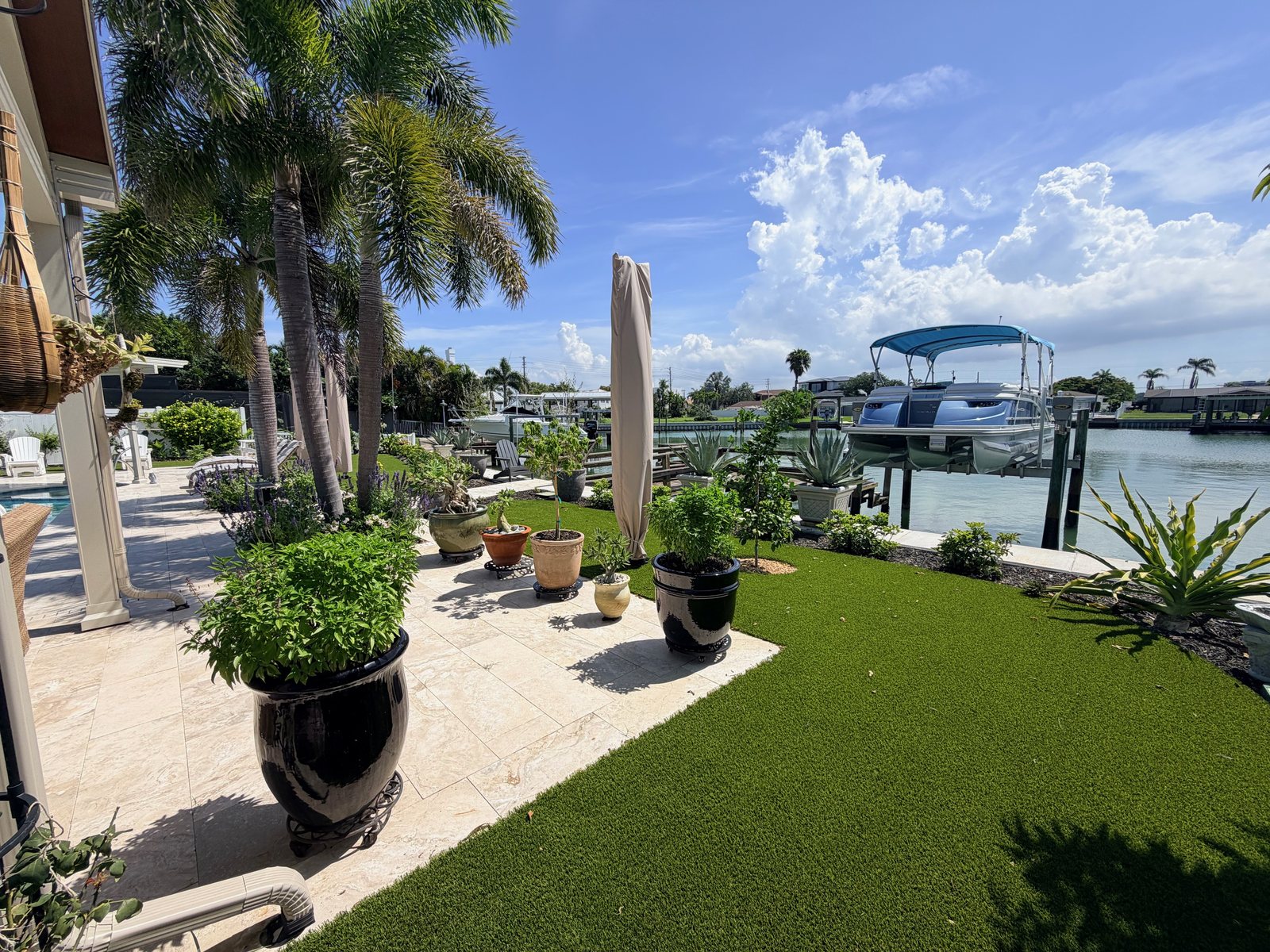 Finished artificial turf beside the travertine patio and Clearwater waterfront at Ed Brusic's home