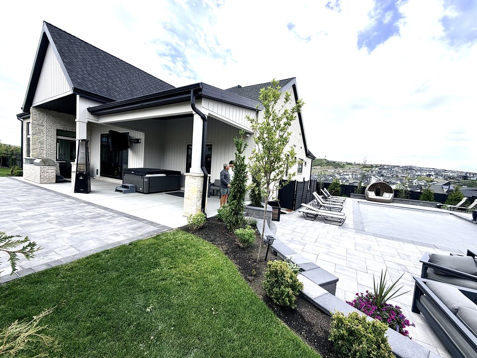 Modern home with paver driveway and landscaped entry