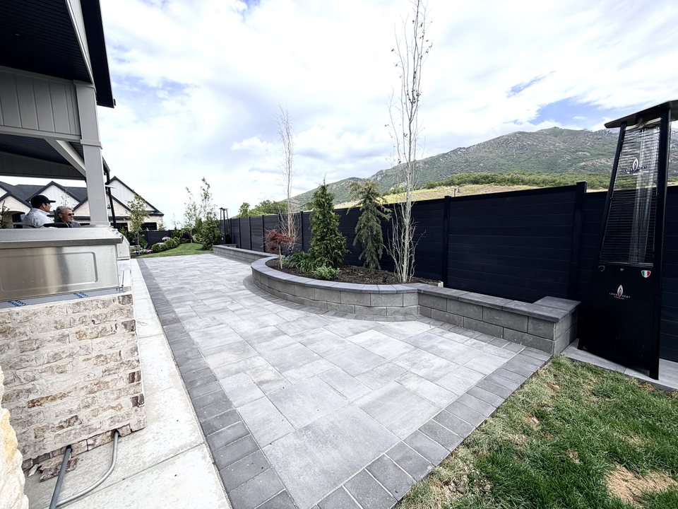 Mountain-view paver patio with a finished outdoor living space