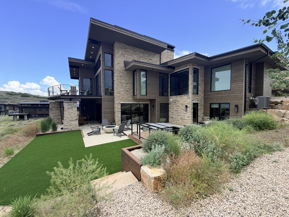 Modern estate with low-maintenance synthetic turf landscaping