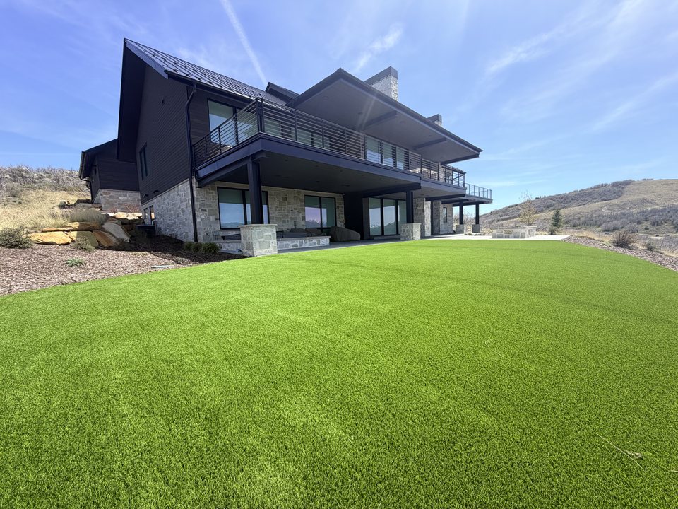 Mountain home with a lush finished artificial turf lawn