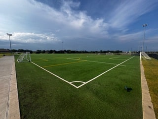 Backyard sport court with synthetic turf surface